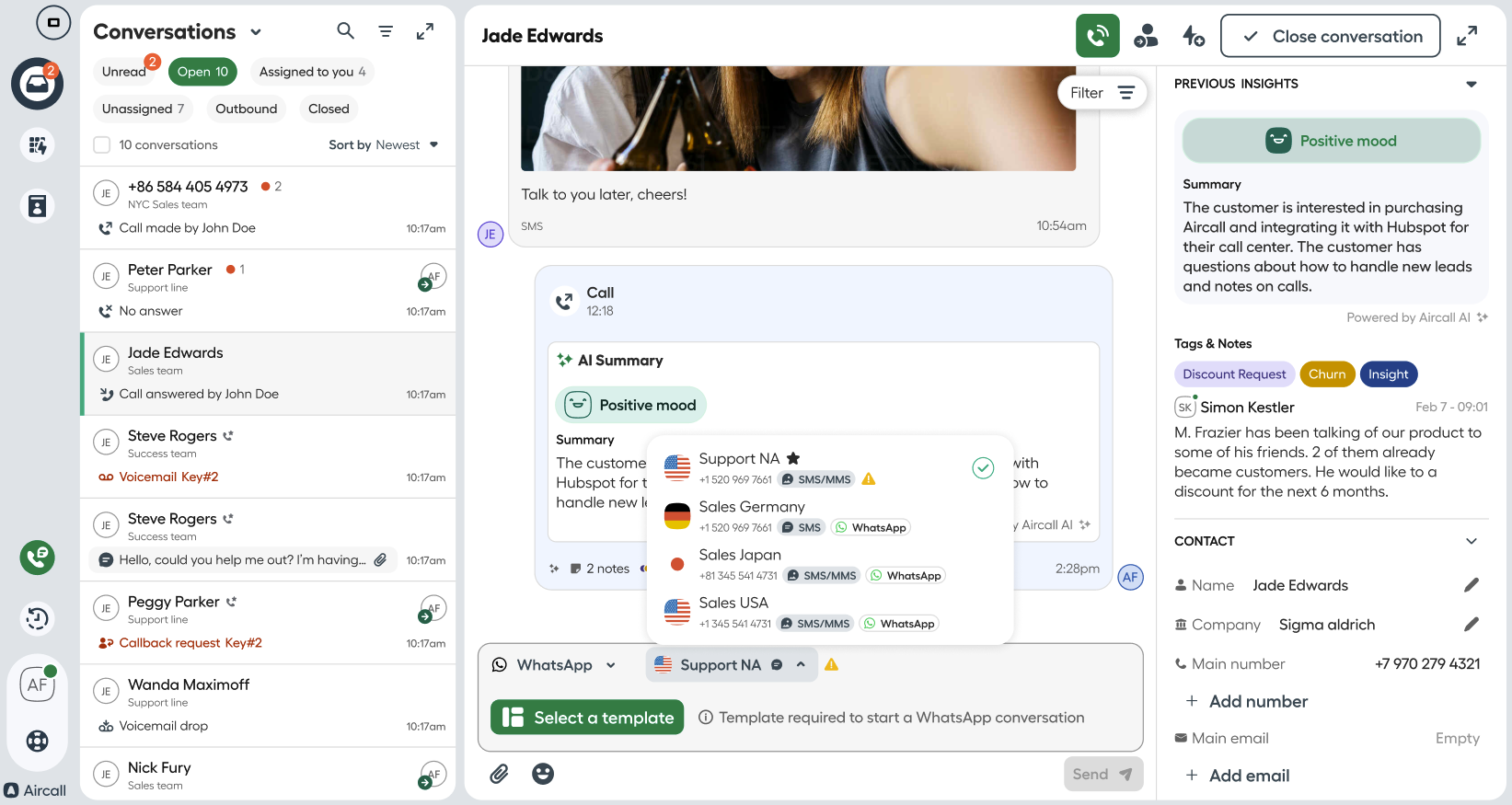 An active conversation view in Aircall Workspace with a dropdown showing available sender numbers — including Support NA, Sales Germany, Sales Japan, and Sales USA — each with icons for SMS, MMS, and WhatsApp. Some numbers show warnings for unavailable messaging types..png